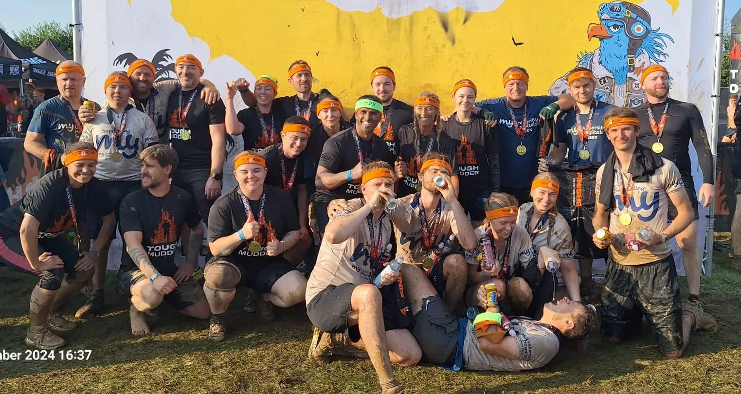 A group of My Charity supporters covered in mud, posing after completing Tough Mudder