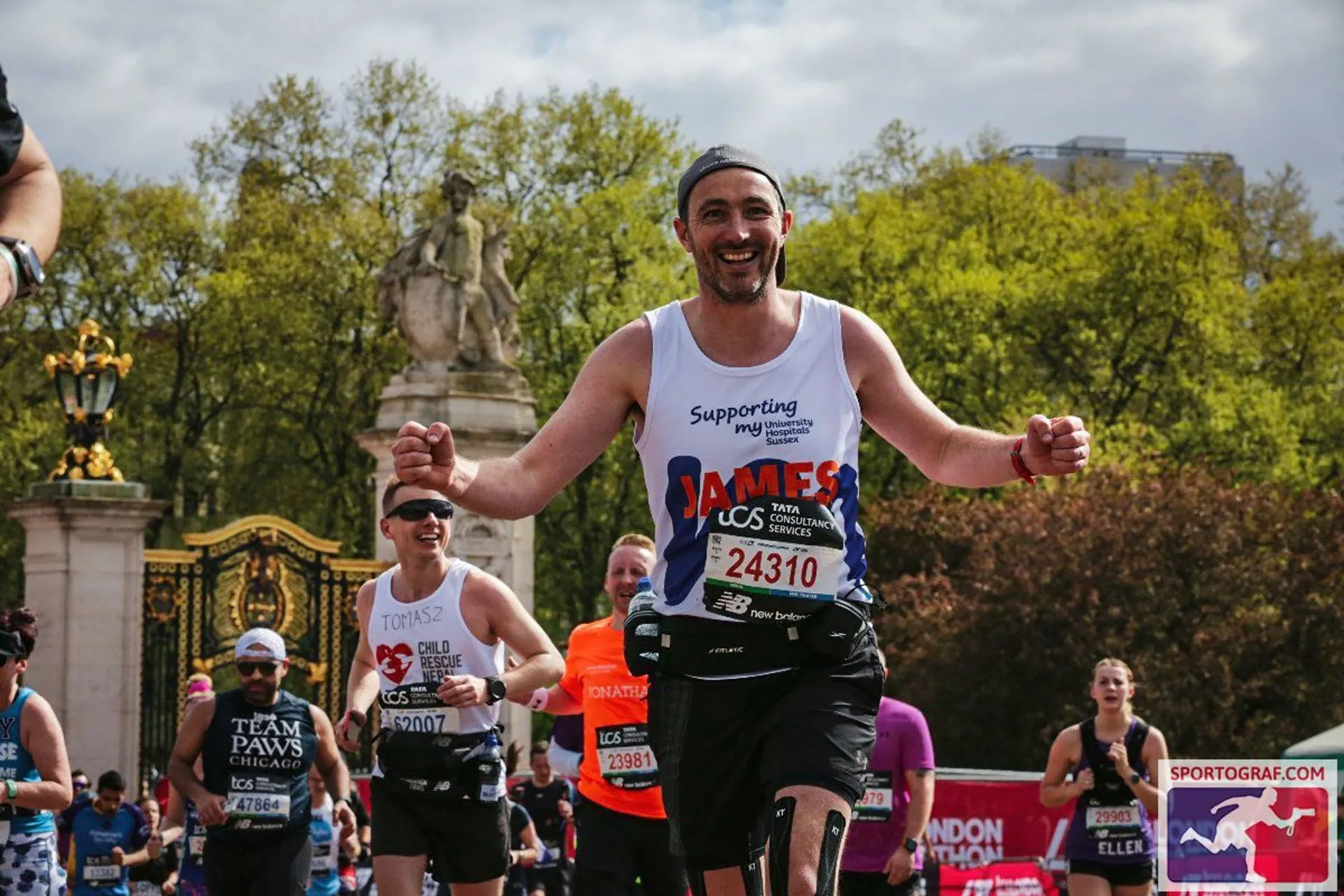 A Royal Parks Marathon runner cheering and wearing a My Charity branded vest